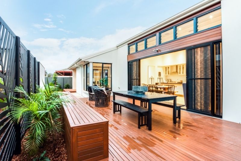 wet decking above the ground with a dining table and chairs