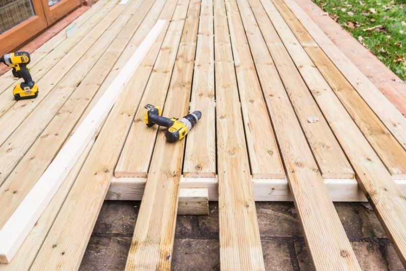 Timber decking boards being installed with power drills